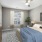 a bedroom with a bed and a fan